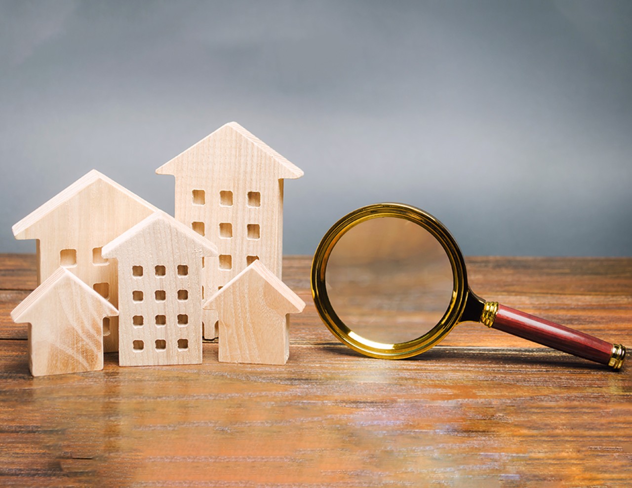 Person holding a decorative house in their palm of their hands