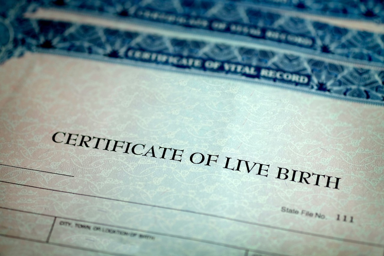 Certificate paper that says "Certificate of Live Birth" across the top