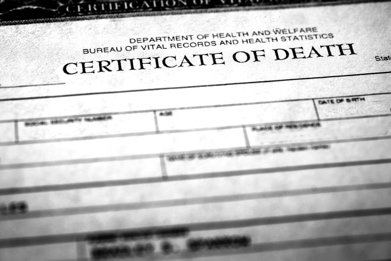 Black and white image of certificate paper that says "Certificate of Death" across the page