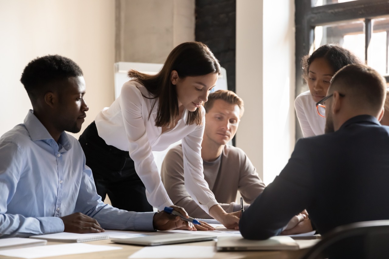 Group of people around a table reviewing documents